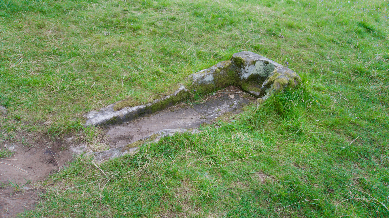 The stone sarcophagus in the churchyard.