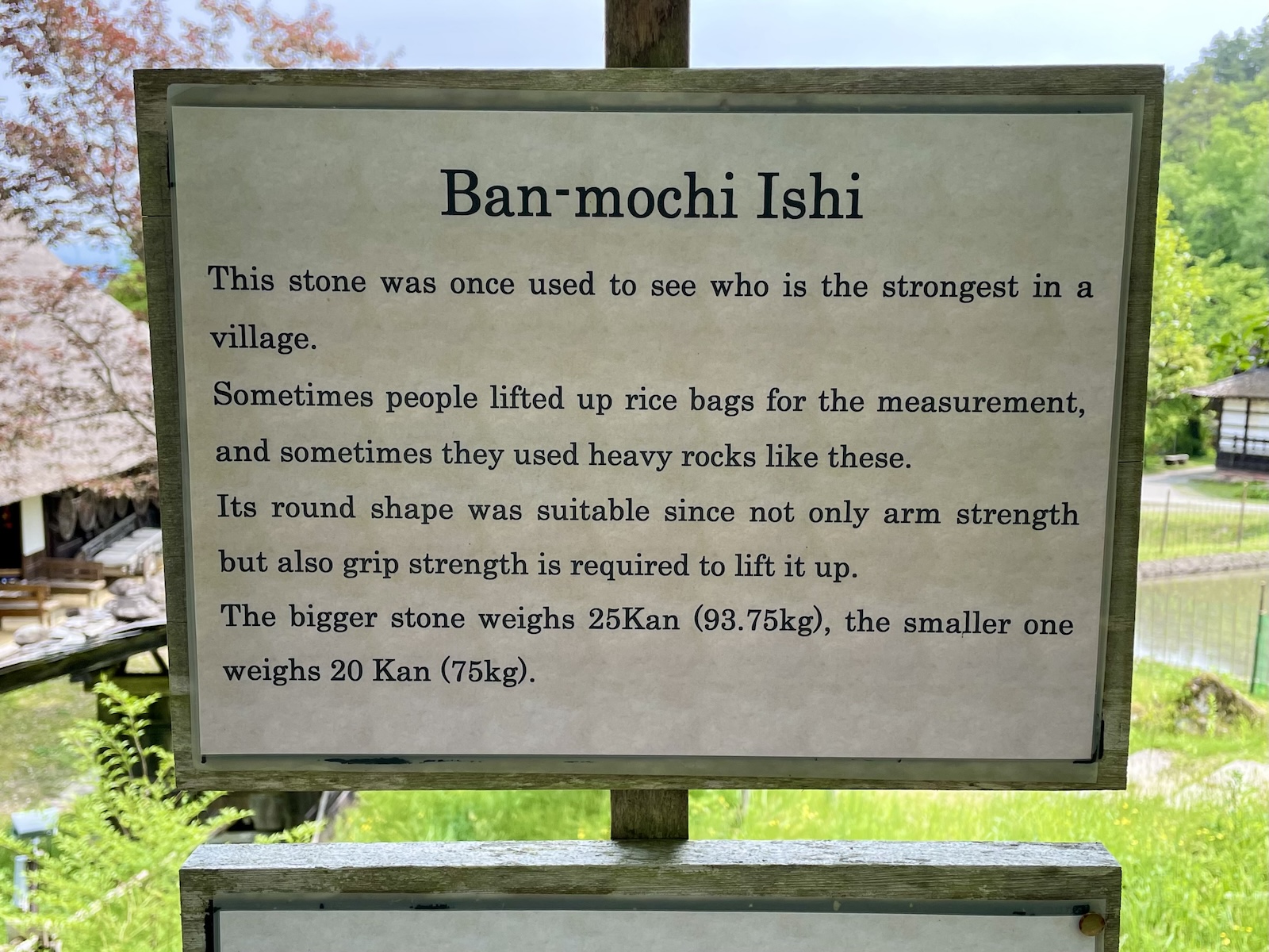 A close up of the Hida Folk Village stones' sign in English.