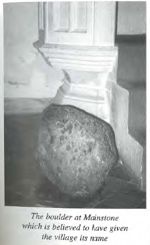 A scan of a page showing a black and white photo of the Maegen Stone next to the pulpit, the caption reads 'The boulder at Mainstone wich is believed to have given the village its name'.