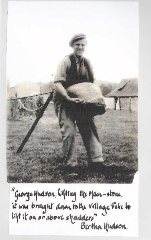 A scan of a photo, along with a caption showing George Hudson lifting the 'Maen-stone' at the village fete.