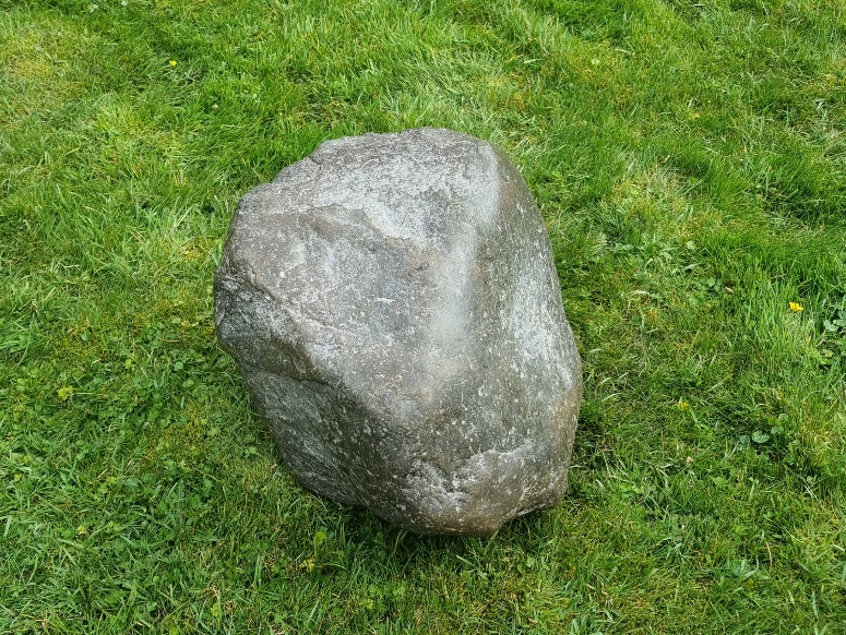 The Maegen Stone sat on grass outside.