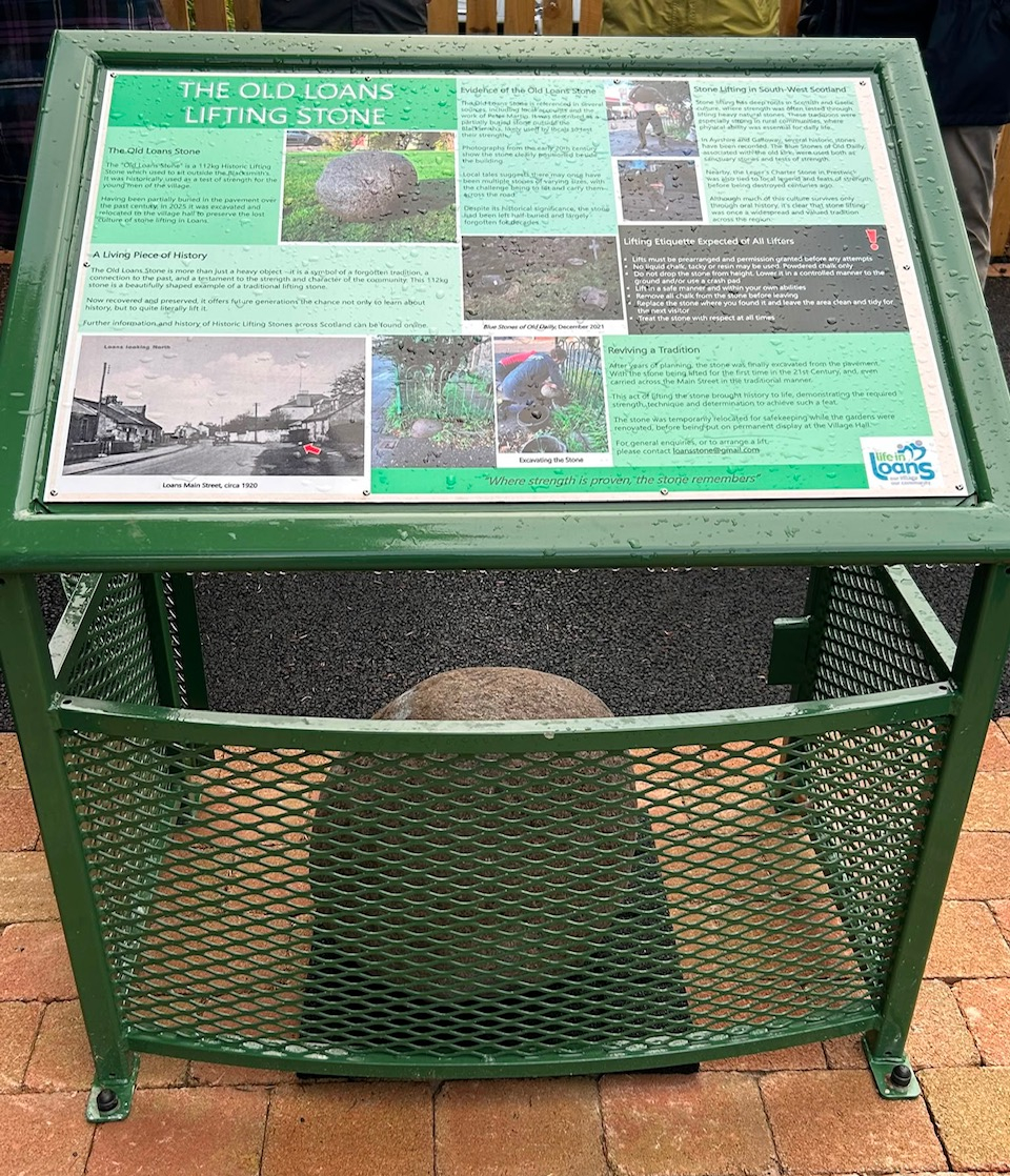 The new Old Loans Stone information board. It's a green metal cage that contains the stone, with a large panel on top sharing information about the stone.