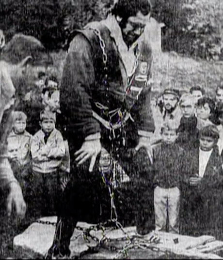 A scan of a newspaper photo showing Torkel Ravndal in his hip lift harness.