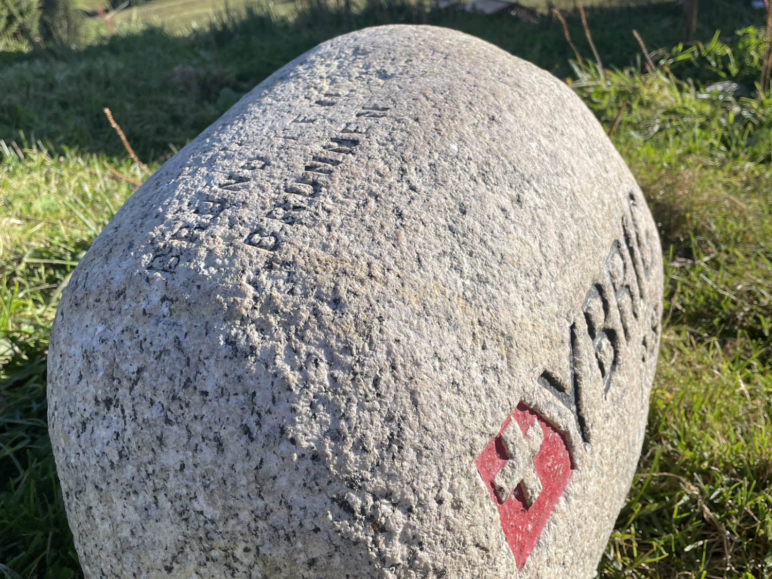 A view of the Ybrig Stone from above the top-left corner, you can read the name 'BRUNO PFYL' on the top of the stone and the word 'BRUNNEN' engraved on the next line below.